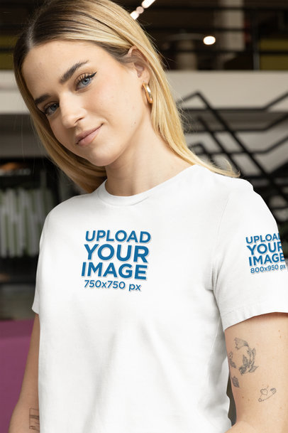 Bella Canvas T-Shirt Mockup of a Woman with Arm Tattoos in an Office