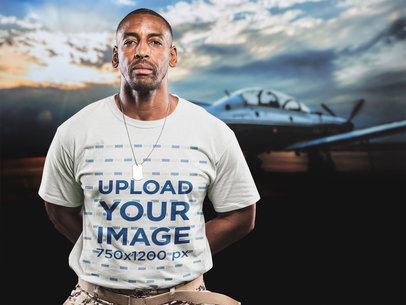 Veteran Wearing a T-Shirt Mockup Against a Picture of a Plane