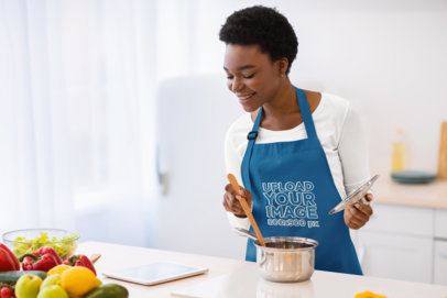 Apron Mockup of a Woman Following an Online Food Recipe