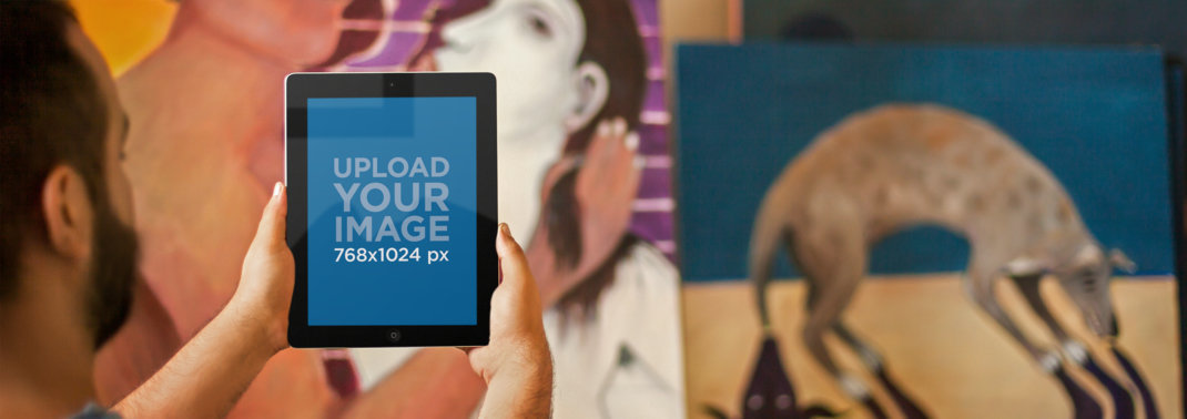 Mockup of an Artist Holding an iPad in a Vertical Position 