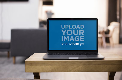 Front Shot of a MacBook Mockup Standing on the Corner of a Wooden Desk a20991
