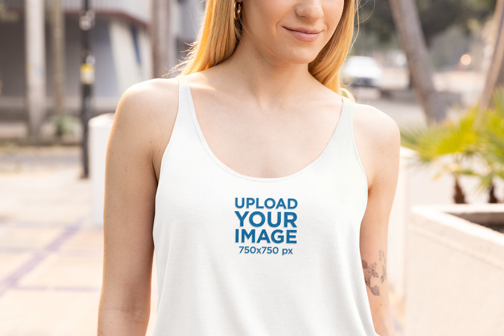 Bella Canvas Tank Top Mockup of a Woman with an Arm Tattoo Walking on the Street