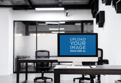 iMac Mockup Standing on a Black Desk at an Office