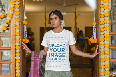 Gildan T-Shirt Mockup of a Woman Wearing India Ornaments Posing by Decorative Flowers