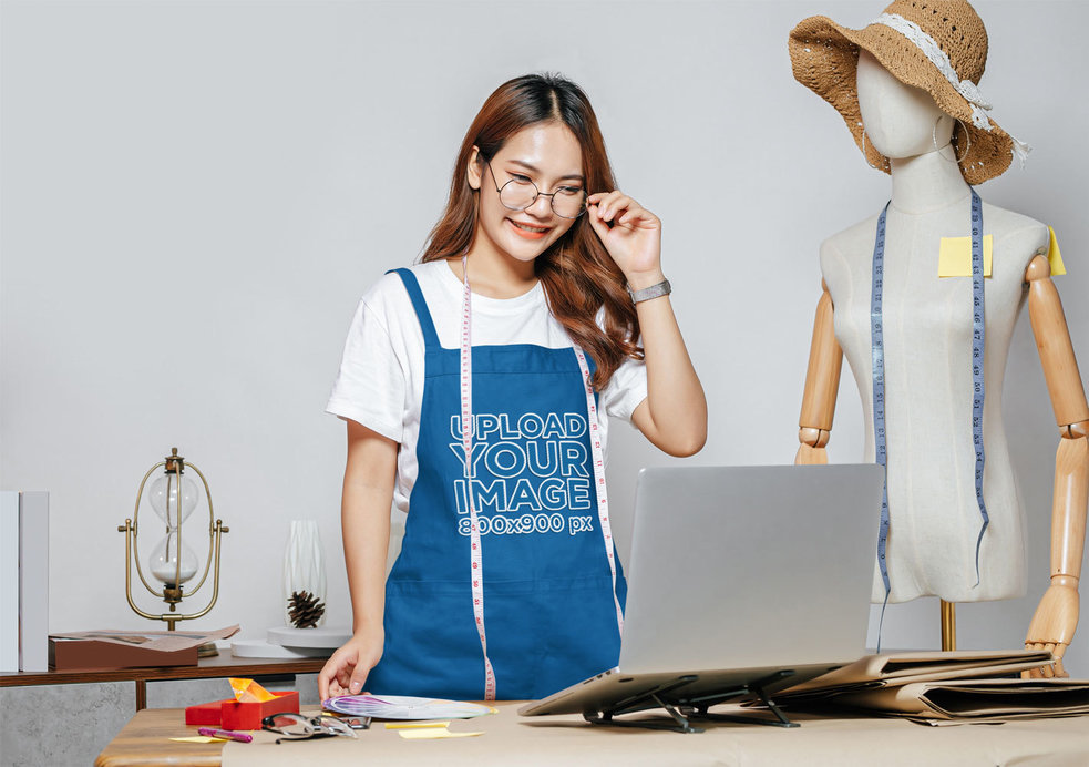 Mockup of a Young Fashion Design Student Wearing an Apron