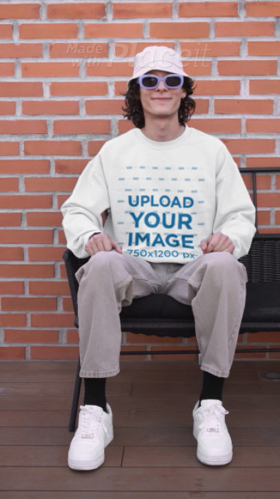 T-Shirt and Sweatshirt Video Featuring a Happy Man Sitting on a Bench While Making a TikTok