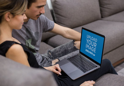 Coworkers Watching a MacBook Mockup Sitting on a Sofa a20992