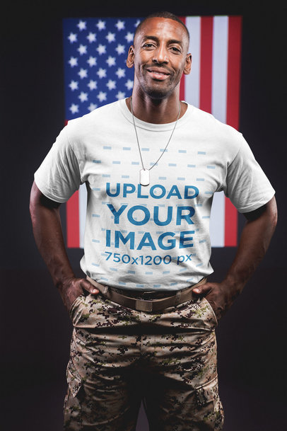 Smiling Veteran Wearing a Round Neck T-Shirt Mockup Against an American Flag