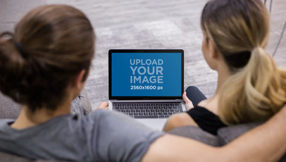 Overshoulder Shot of a Couple Using a MacBook Mockup a20994