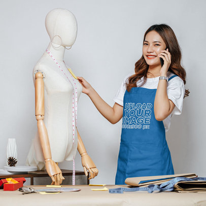 Embroidered Apron Mockup Featuring a Happy Woman Working in a Fashion Studio