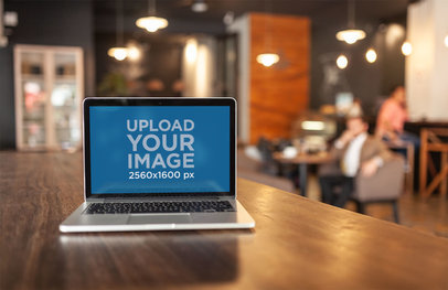 MacBook Mockup Standing on a Wooden Table at a Startup