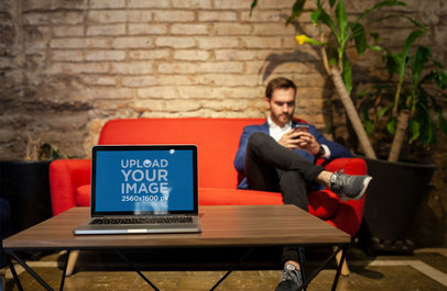 MacBook Pro Mockup Standing on a Desk at a Waiting Room