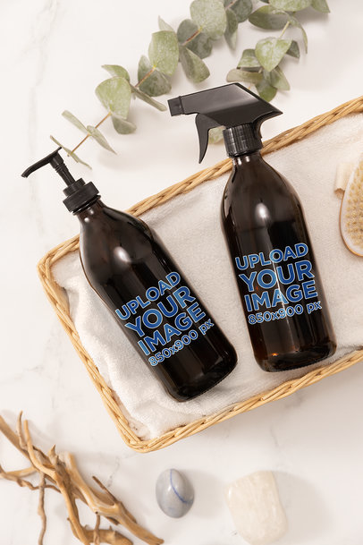 Mockup of a Glass Spray Bottle and Glass Pump Bottle Placed on a Nice Basket