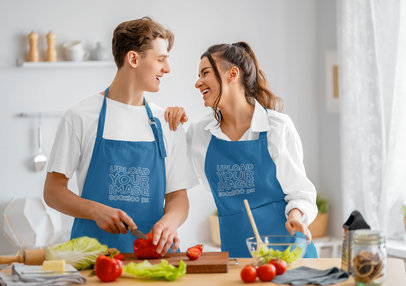 Embroidered Apron Mockup Featuring Happy Couple Cooking a Salad