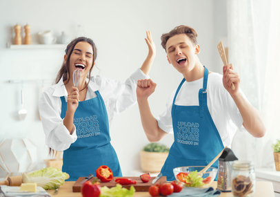 Apron Mockup of a Joyful Couple Singing in the Kitchen While Cooking