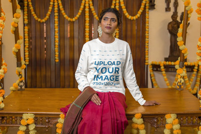 Sweatshirt Mockup of a Woman with Traditional Garments Sitting in a Flower-Decorated Room