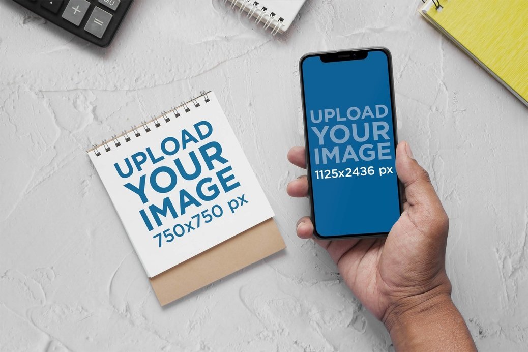 Mockup of a Person Holding an iPhone 13 Featuring a Notebook