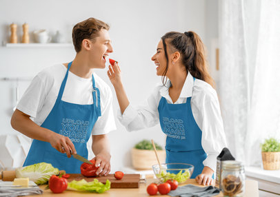 Apron Mockup Featuring a Cheerful Couple Preparing a Meal