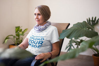 T-Shirt Mockup of a Senior Lady Looking to the Window