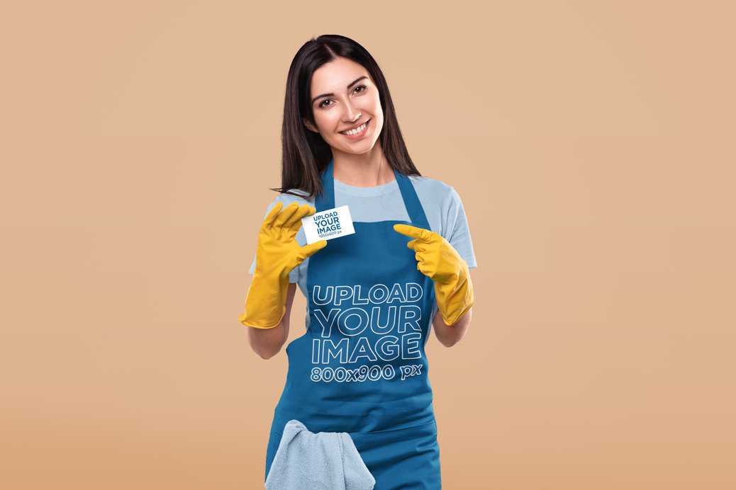Apron Mockup of a Smiling Woman Pointing at a Business Card