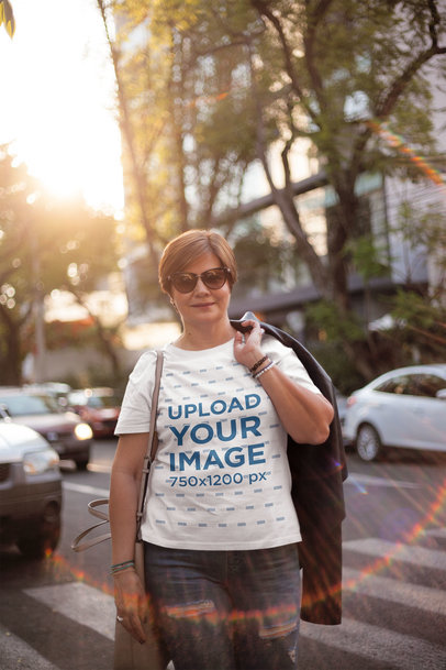 Middle Aged Woman Wearing a T-Shirt Mockup Carrying a Jacket on her Back
