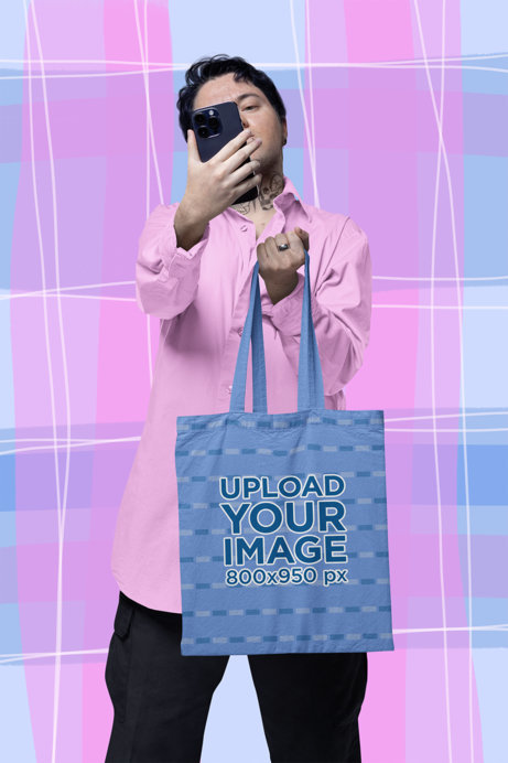 Tote Bag Mockup Featuring a Man Taking a Selfie 