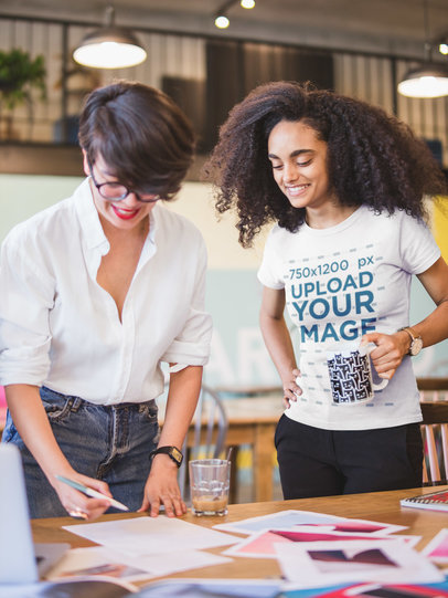 Woman Wearing a T-shirt Mockup Looking at a Mood Board 