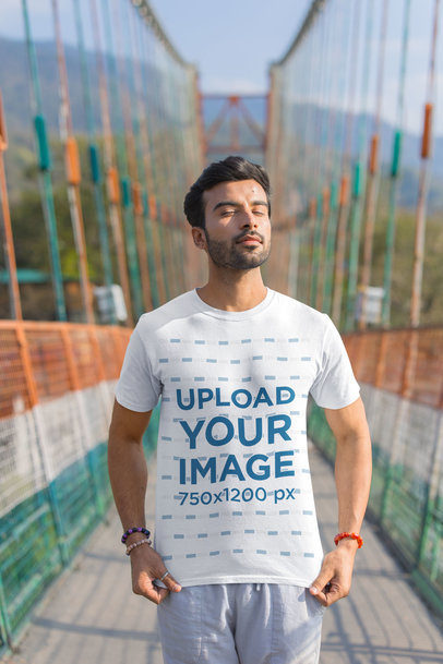 Gildan T-Shirt Mockup of a Calm Man Posing With His Eyes Closed in a Bridge