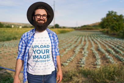Round-Neck Tee Mockup of a Happy Bearded Man Posing in a Cabbage Field