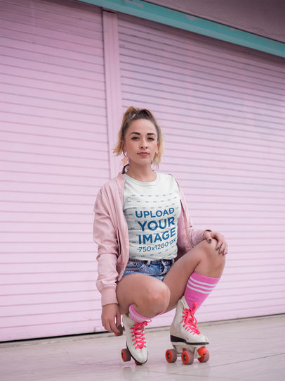 Woman with Roller Skates Wearing a T-Shirt Mockup Against a Pink Metal Curtain