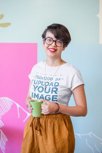 Hipster Woman Wearing a T-Shirt Mockup Holding a Cup of Coffee