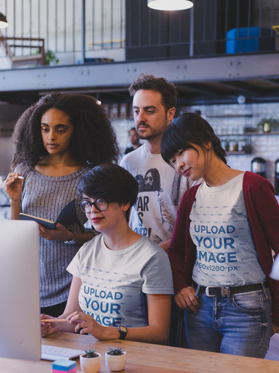 Group of Coworkers at a Startup Wearing T-Shirts Mockup While at a Meeting