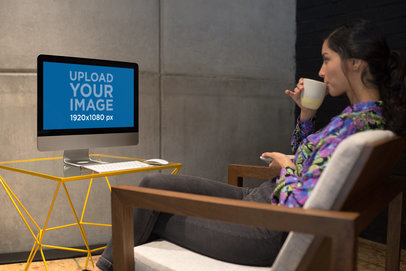 Woman Sipping Tea in Front of an iMac Mockup