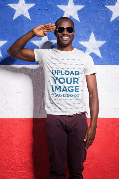 Labor Day Mockup of a Cheerful Man Wearing a T-Shirt and Doing a Military Salute