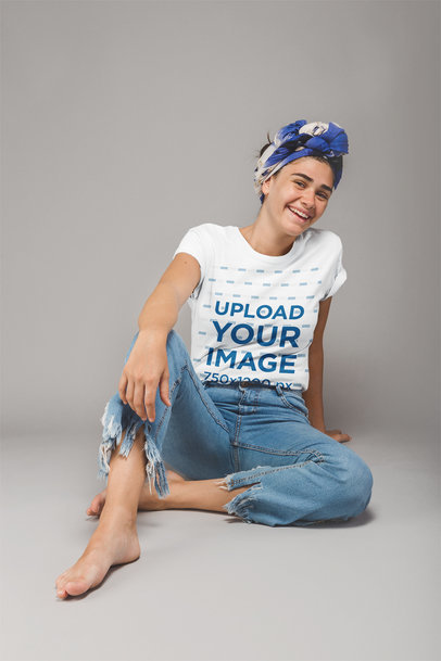 Young Woman Wearing a T-Shirt Mockup Sitting on a Photo Studio