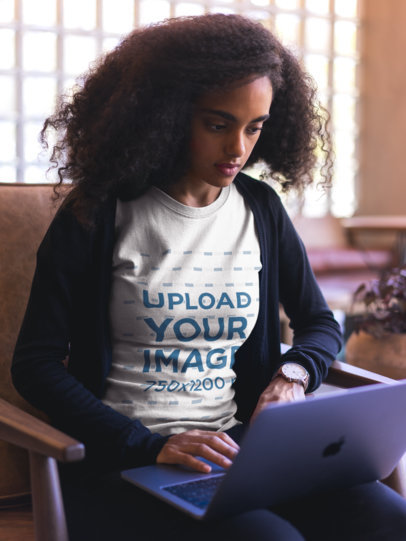 Woman Wearing a Round Neck Tee Mockup Working with a Laptop