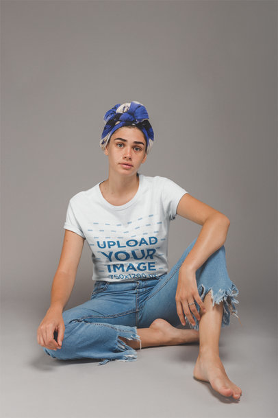 T-Shirt Mockup of an Artist Sitting on the Floor of a Photo Studio