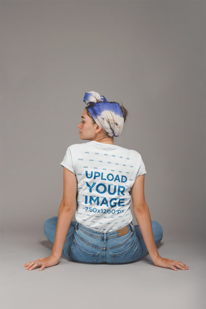 Back Shot of an Artist Wearing a T-Shirt Mockup Sitting on the Floor