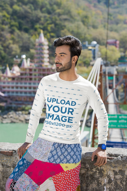 Bella Canvas Long-Sleeve Tee Mockup Featuring a Man Posing by a Rock Bridge