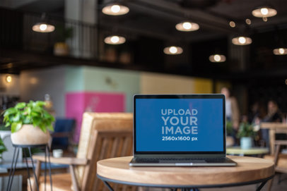 MacBook Pro Mockup Standing on a Small Round Table