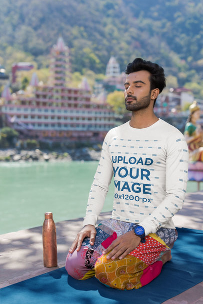 Bella Canvas Long Sleeve Tee Mockup of a Bearded Man Meditating by a Lake