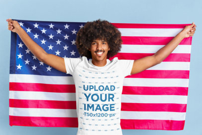 Patriotic Mockup Featuring a Man Wearing a T-Shirt While Holding a Flag