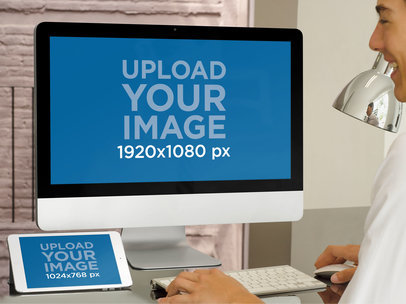 Mockup of an iMac and an iPad Featuring a Smiling Man Working
