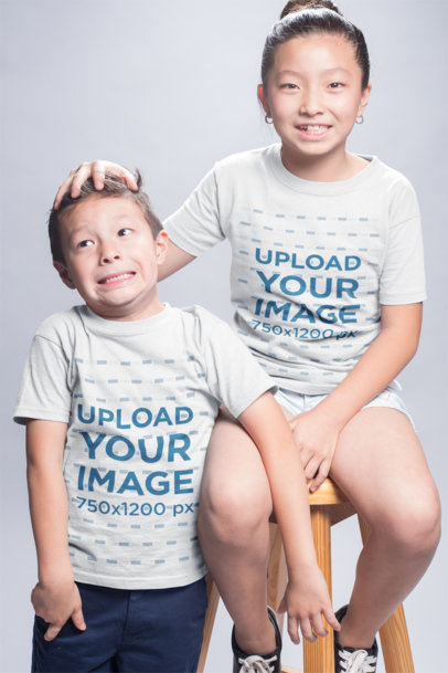 T-Shirt Mockup of a Girl Playing with her Younger Brother