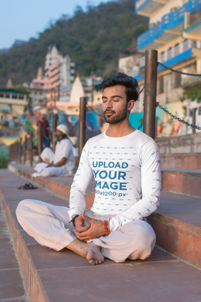 Bella Canvas Long Sleeve Tee Mockup of a Calm Man Meditating on a Staircase