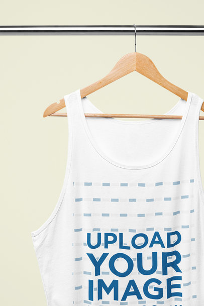 Mockup of a Bella Canvas Tank Top Placed on a Wooden Hanger