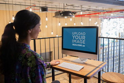 Woman Working with iMac Mockup at her Workstation