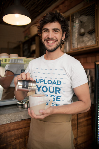 Mockup of a Smiling Waiter Wearing a T-Shirt while Preparing a Coffee