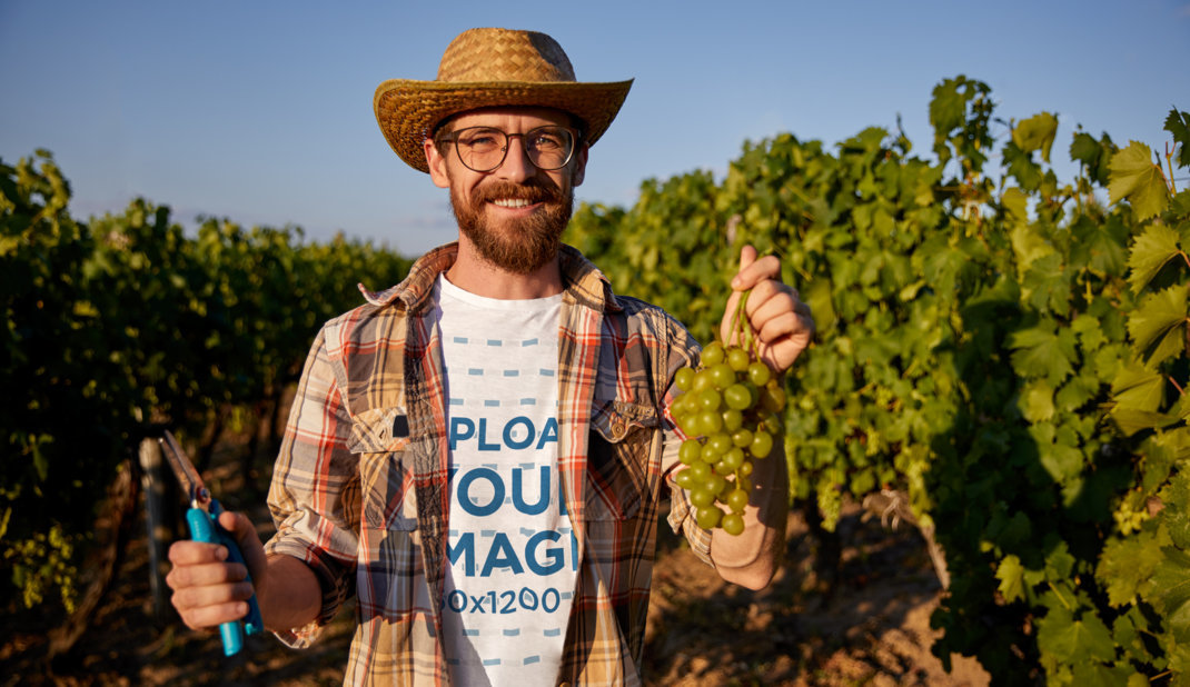 Round-Neck Tee Mockup of a Bearded Farmer Cutting Fresh Grapes 