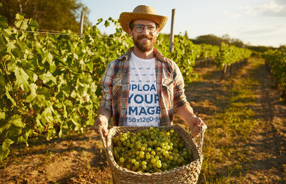 Round-Neck T-Shirt Mockup Featuring a Happy Farmer Carrying a Basket With Grapes
